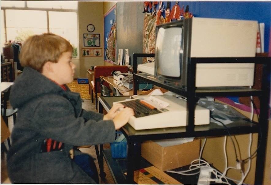 Young Rob Kendal sitting at a BBC computer